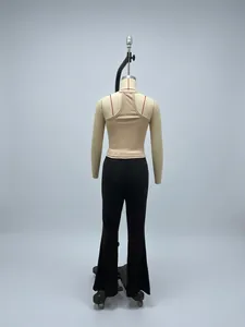 Detailed shot of beige ribbed knit tank top and black flared trousers on a mannequin