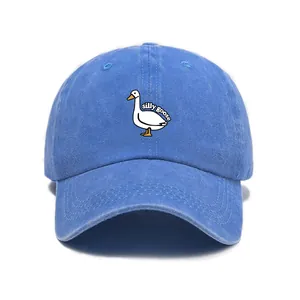 Detail of blue washed cotton baseball cap featuring silly goose embroidery and retro texture