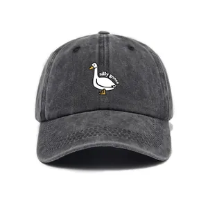 Close-up of silly goose embroidery on a charcoal grey washed denim baseball cap