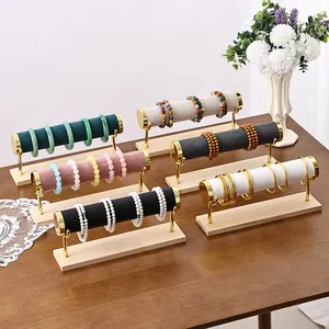 Multi-tier jewelry display stand with velvet rollers and solid wood base for bracelets