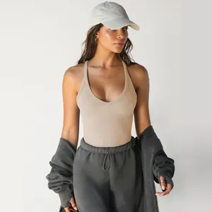 Women's khaki ribbed knit V-neck tank top styled with grey joggers and a zip-up hoodie