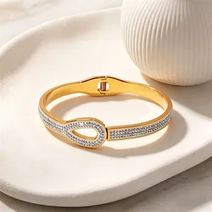 Minimalist gold-plated stainless steel spring bangle with sparkling crystal inlay