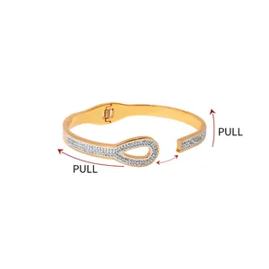 Detail of gold spring bracelet with pull mechanism and sparkling diamond accents