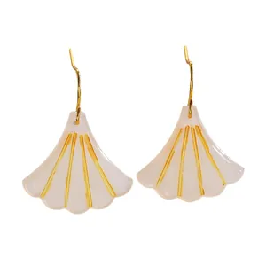 Detail of ginkgo leaf earrings with pearl white finish and gold radial lines
