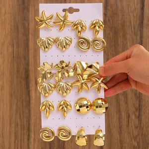 Detailed set of 12 gold plated earrings featuring starfish shell and geometric designs