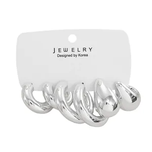 Detailed view of five-piece silver C-shaped hoop earring set on jewelry display card
