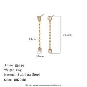 Detail view of stainless steel 18K gold earrings with tassel chain and zircon studs