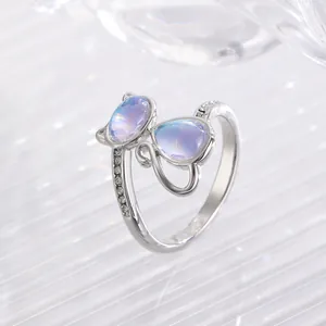 Macro shot of silver adjustable cat paw ring featuring blue opal stones and zircon