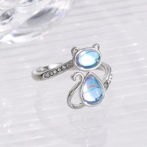 Macro detail of adjustable cat ring featuring blue moonstone and pavé zircon accents