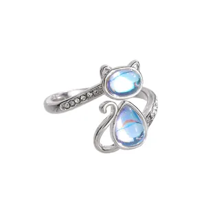 Macro view of adjustable cat paw ring with zircon accents and moonstone-like gems