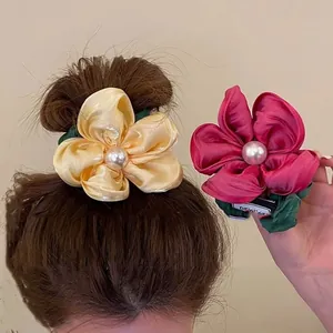 Floral scrunchies with large pearls and green leaves in yellow and rose pink colors