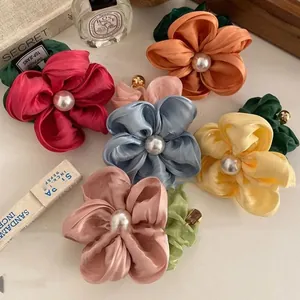 Floral satin scrunchies with faux pearls in multiple colors including burgundy and blue