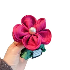 Handmade rose red floral scrunchie with satin petals and a white imitation pearl detail