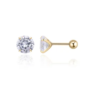 Detail of gold S925 sterling silver stud earrings with 4-prong set cubic zirconia stones