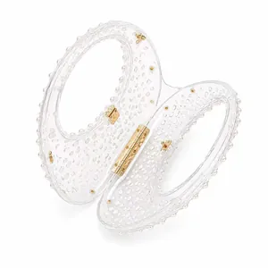 Modern transparent acrylic handbag with unique beaded texture and gold metallic hardware