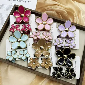 Detail of colorful plumeria flower hair claw clip sets in multiple shades on display