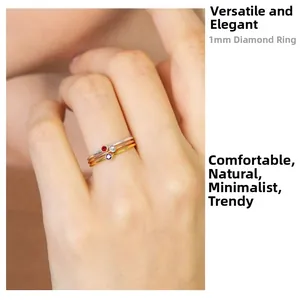 Detailed view of three 1mm thin rings in gold and silver with colorful crystal stones