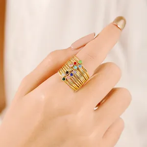 Detail of gold multi-layered ring featuring twelve colorful micro-inlaid round zirconias
