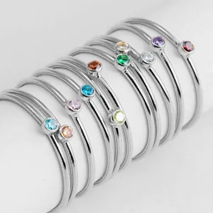 Polished silver minimalist stacking rings with colorful round-cut crystal gemstones