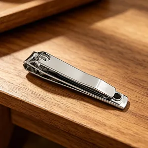 Stainless steel large nail clippers with splash-proof design on wooden table