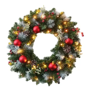 Christmas wreath with LED lights, red berries, and snow-dusted pine needles for door decor