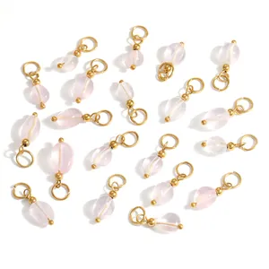 Detailed flat lay of pink oval stone pendants with gold plated DIY jewelry findings