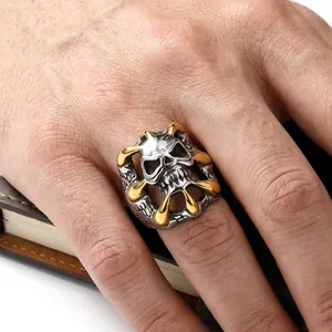 Men's skull ring in vintage silver and gold finish with punk rock aesthetic