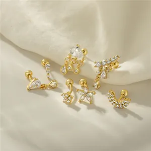 Macro detail of S925 silver gold cartilage studs with moon and star zircon pavé designs