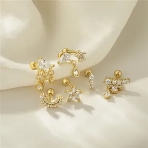 Macro detail of gold S925 silver ear studs with cubic zirconia and screw ball backs