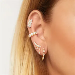 Detailed close-up of golden S925 sterling silver ear cuff set with pavé cubic zirconia