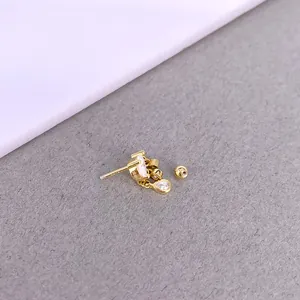 Macro shot of S925 silver gold-plated cartilage stud with cubic zirconia and screw back