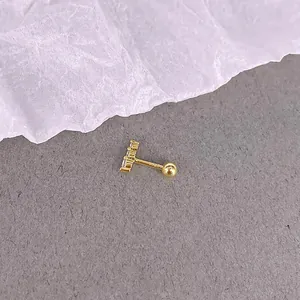 Detailed macro view of S925 hallmark on gold threaded ear stud with three zircons