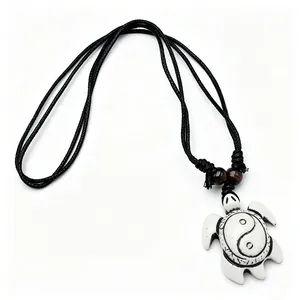 Detail view of the vintage resin turtle pendant necklace featuring a Tai Chi Yin Yang symbol.