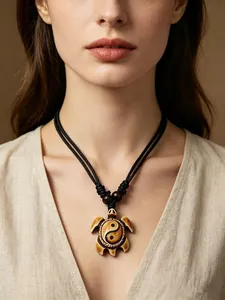Detailed view of retro Yin Yang turtle resin pendant necklace in tribal style worn by model
