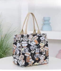 Detail of the durable canvas material and wide beige woven handle on a cute cat tote bag