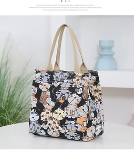 Detail of cartoon cat canvas tote with khaki handles and cute cat pattern print