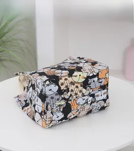 Detail of canvas bag with colorful cartoon cat patterns and durable khaki handles