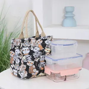 Canvas lunch tote bag with cartoon cat patterns and beige handles for daily travel