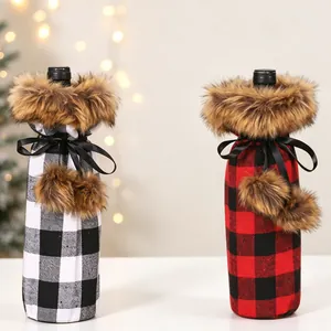 Detail of buffalo plaid wine bottle covers with faux fur collars and decorative pom-poms