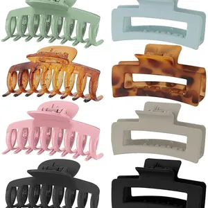 Set of 8 matte hair claw clips in various colors and shapes on white background
