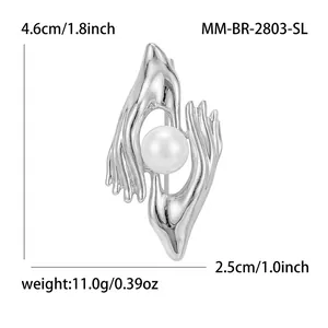 Creative hand holding pearl brooch in silver finish elegant suit pin accessory gift