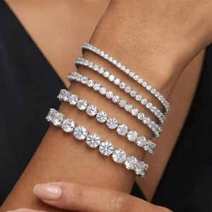 Close-up of five S925 silver tennis bracelets with varying moissanite stone sizes on wrist