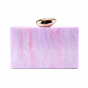 Detail of starry pink marble acrylic clutch with rose gold pebble-shaped metal clasp