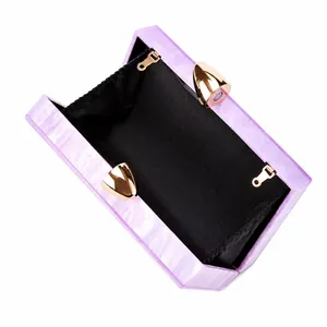 Detail view of the purple marble acrylic evening clutch with gold metal clasp and lining