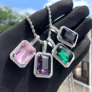 Close-up of four hip hop square gemstone pendants in pink, purple, green and blue colors.