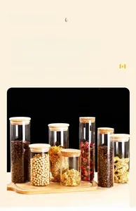 Set of clear glass storage jars with wooden lids for coffee beans and dry food