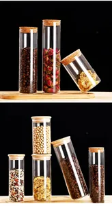 Close-up of glass storage jars with cork lids and wooden caps for coffee and tea