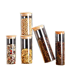 Set of four clear glass storage jars with airtight bamboo and cork lids for kitchen spices