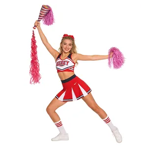 Detail of red and white cheerleader uniform set with pleated skirt and pom poms