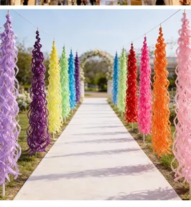 Rainbow spiral hanging ornaments displayed in a vibrant outdoor garden party setting